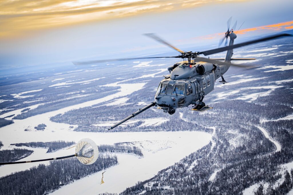 A U.S. Air Force HH-60G Pave Hawk assigned to the 210th Rescue Squadron, 176th Wing, Alaska Air National Guard performs a helicopter air-to-air refueling with a U.S. Marine Corps KC-130J assigned to Marine Aerial Refueler Transport Squadron (VMGR) 153, Marine Aircraft Group 24, 1st Marine Aircraft Wing during a deployment for training (DFT) at Joint Base Elmendorf–Richardson, Alaska, Dec. 17, 2024. The DFT provided VMGR-153 pilots and aircrew with unit level training that enhanced squadron combat readiness while supporting community relations in remote Alaskan regions during the holiday season. (U.S. Marine Corps photo by Lance Cpl. Moses S. Lopez Franco)